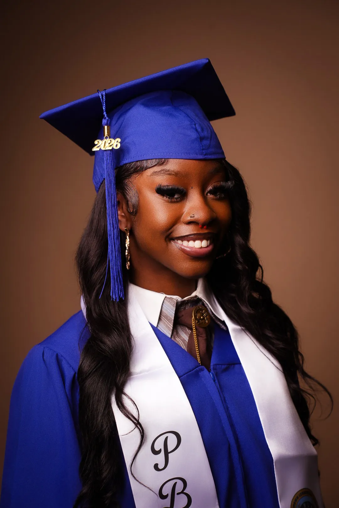 Graduation portrait — blue cap and gown